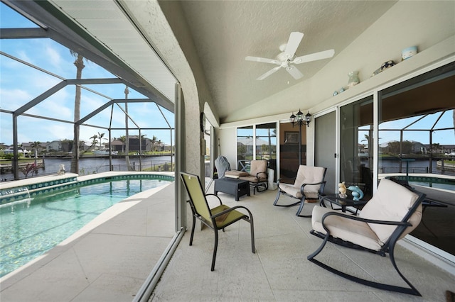 view of pool with a water view, glass enclosure, ceiling fan, and a patio area