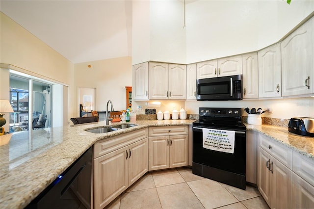 kitchen featuring sink, light stone counters, high vaulted ceiling, light tile patterned flooring, and black appliances