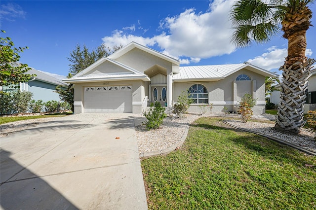 ranch-style house featuring a garage and a front yard