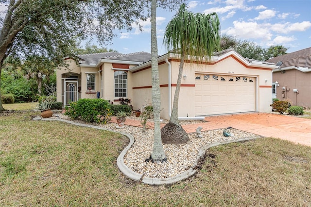 view of front facade with a garage and a front lawn