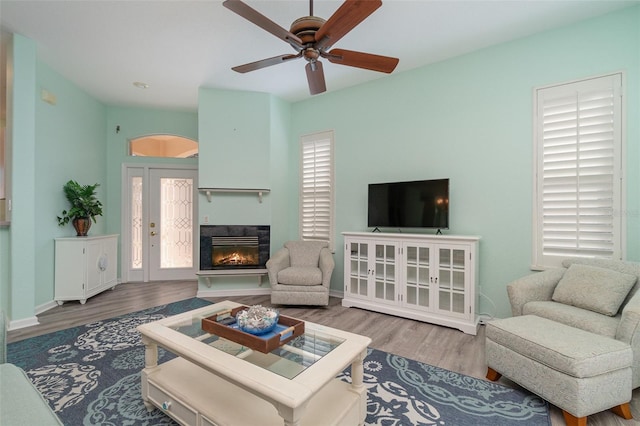 living room featuring hardwood / wood-style flooring, plenty of natural light, and ceiling fan