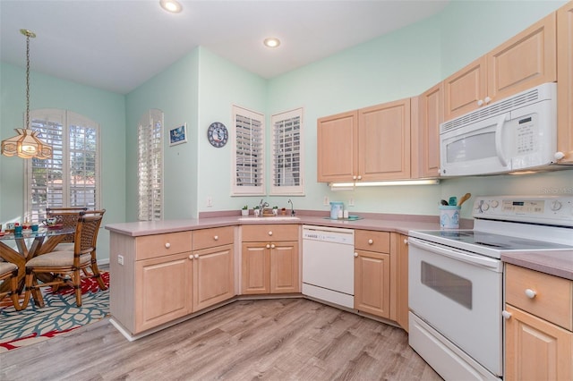 kitchen featuring sink, light hardwood / wood-style flooring, decorative light fixtures, white appliances, and light brown cabinetry