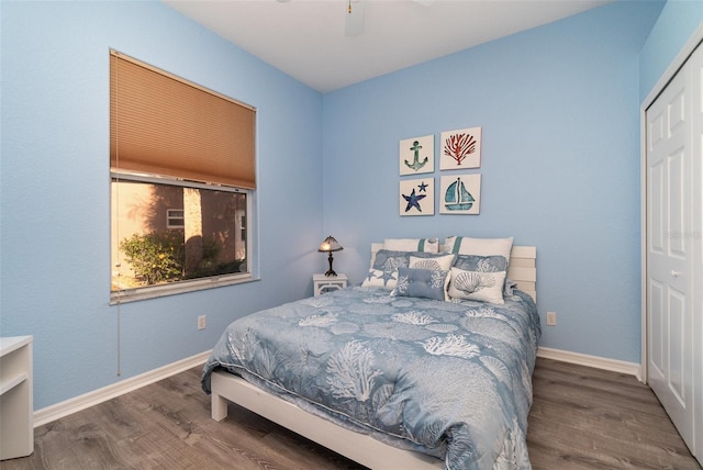 bedroom featuring ceiling fan, a closet, and hardwood / wood-style floors