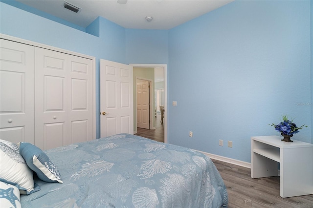 bedroom with light hardwood / wood-style floors and a closet