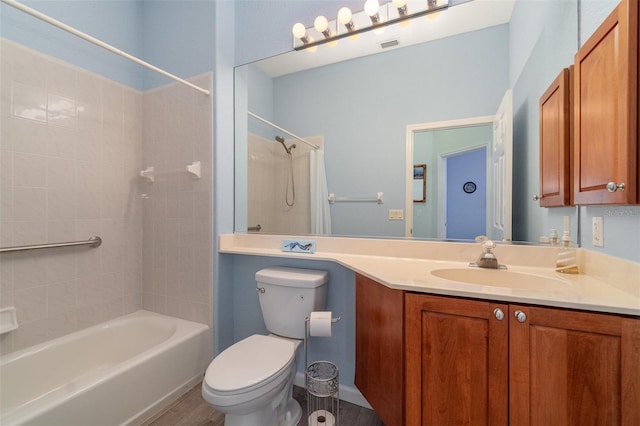 full bathroom with toilet, vanity, tiled shower / bath combo, and hardwood / wood-style flooring