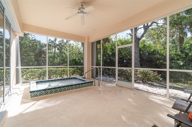 unfurnished sunroom with a wealth of natural light, ceiling fan, and a hot tub