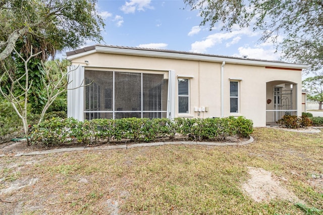 10494 Princess Ct, Punta Gorda, FL 33955 - rear view of house with stucco siding and a yard