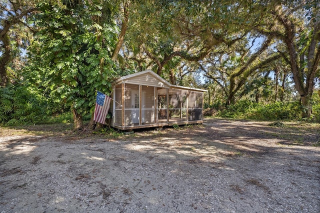 view of outdoor structure featuring a sunroom