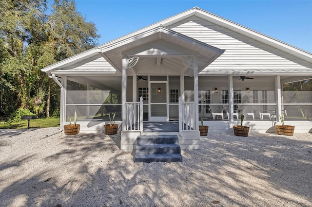 exterior space featuring a sunroom and ceiling fan