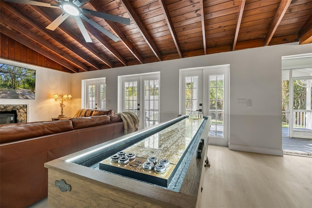 playroom featuring a wealth of natural light, french doors, wood ceiling, and light hardwood / wood-style flooring