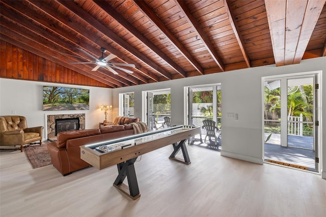 game room featuring a premium fireplace, plenty of natural light, wooden ceiling, and light wood-type flooring