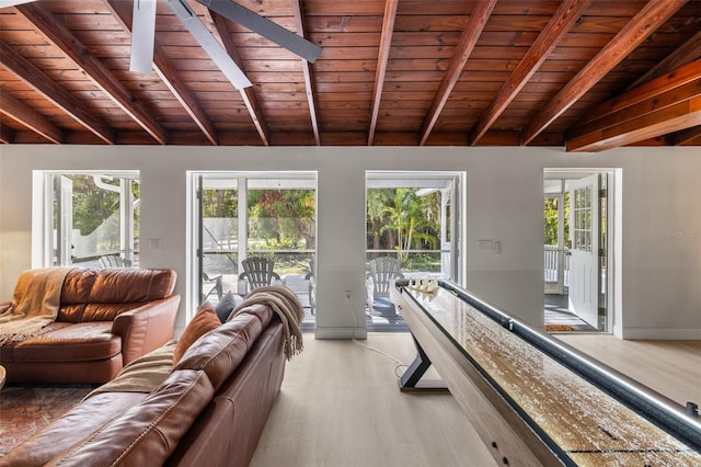 living room featuring beamed ceiling, light wood-type flooring, and wooden ceiling