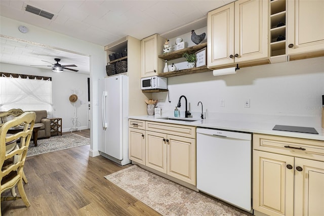 kitchen featuring white appliances, cream cabinets, sink, dark hardwood / wood-style floors, and ceiling fan