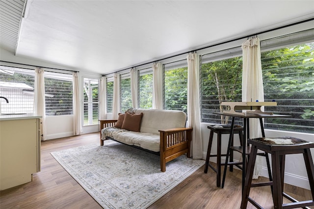 sunroom / solarium featuring sink and vaulted ceiling