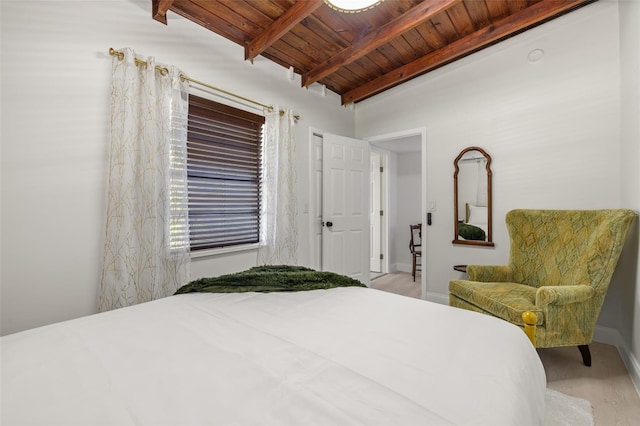 bedroom featuring vaulted ceiling with beams, wood ceiling, and light wood-type flooring