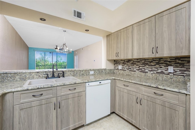 kitchen featuring kitchen peninsula, light brown cabinetry, dishwasher, and sink