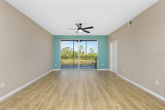 empty room with light hardwood / wood-style flooring and ceiling fan