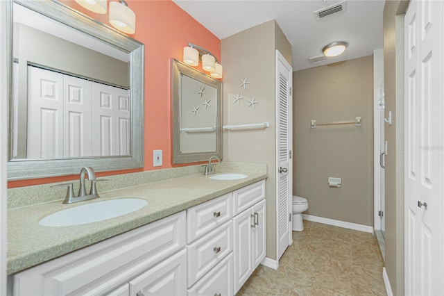 bathroom featuring tile patterned floors, vanity, and toilet