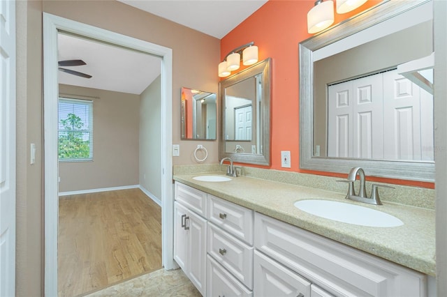 bathroom with hardwood / wood-style flooring, ceiling fan, and vanity