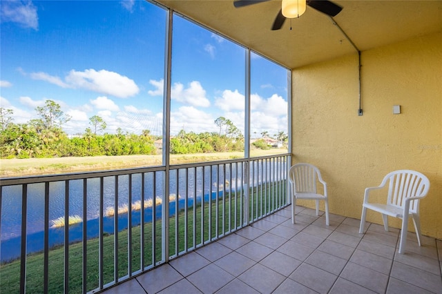 unfurnished sunroom with a water view and ceiling fan