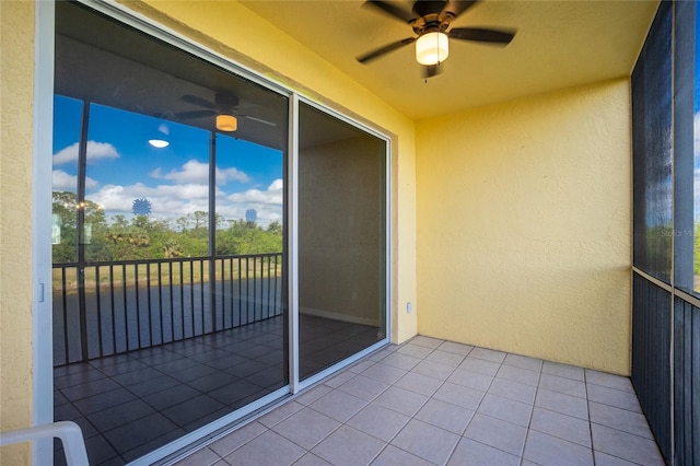 unfurnished sunroom featuring ceiling fan