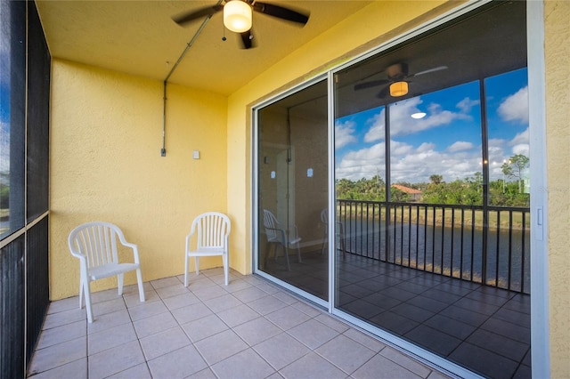 unfurnished sunroom featuring ceiling fan