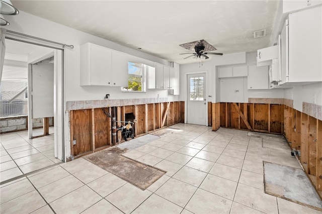 kitchen featuring white cabinetry, ceiling fan, and light tile patterned floors