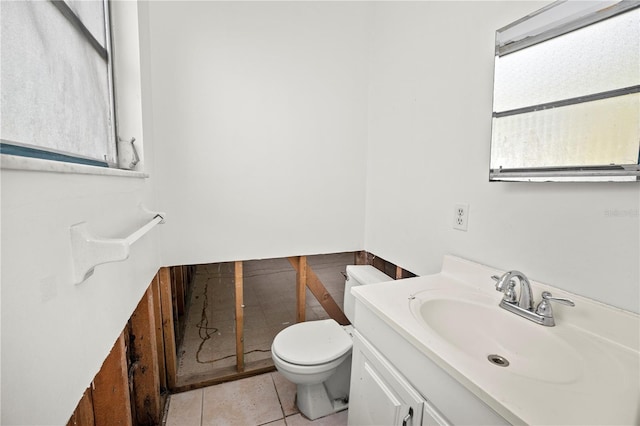 bathroom featuring tile patterned floors, vanity, and toilet