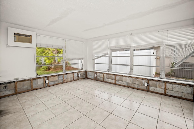 unfurnished sunroom featuring a wall mounted AC