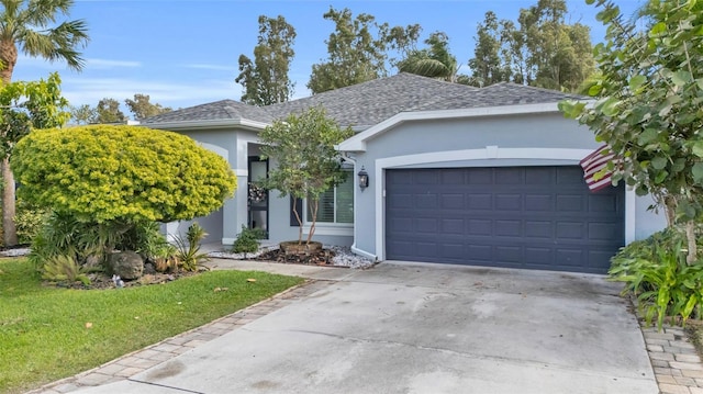 ranch-style home with a garage and a front yard