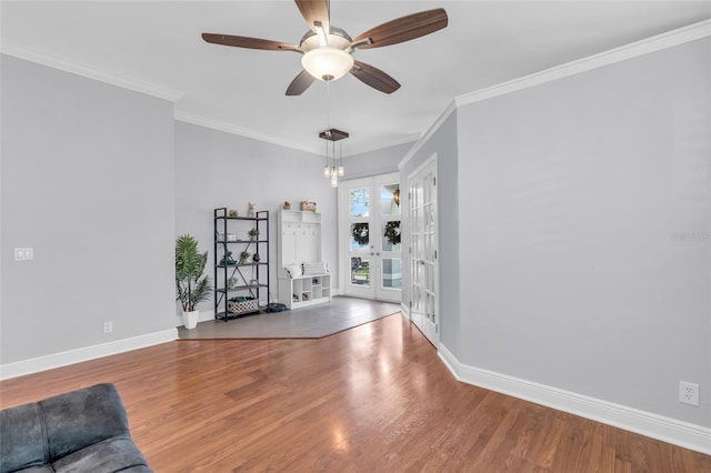 interior space with hardwood / wood-style floors, ceiling fan with notable chandelier, and ornamental molding