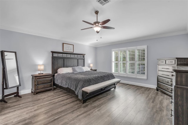 bedroom featuring ceiling fan, crown molding, and wood-type flooring