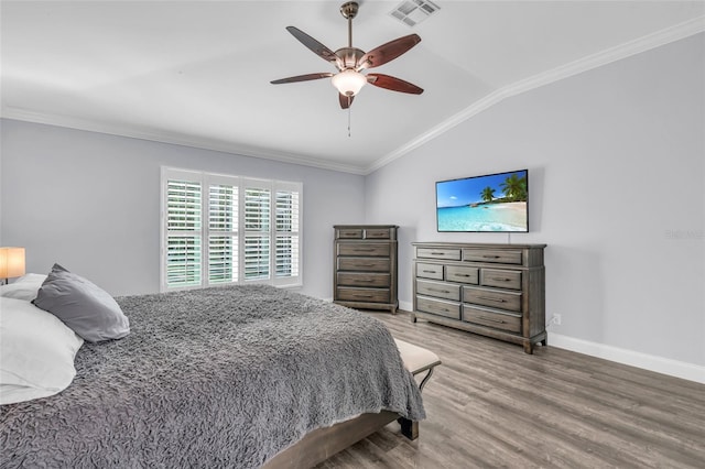 bedroom featuring ceiling fan, crown molding, wood-type flooring, and lofted ceiling