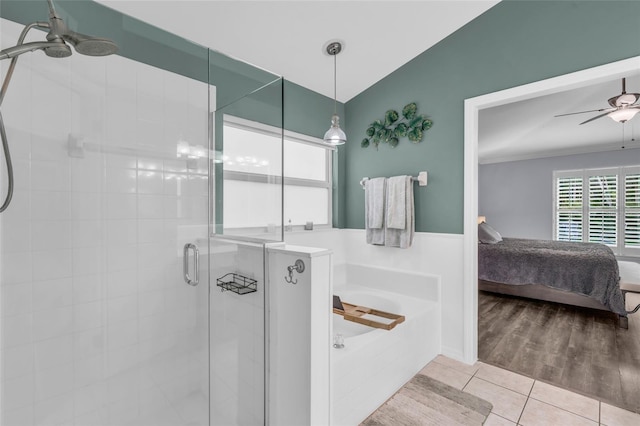 bathroom featuring ceiling fan, independent shower and bath, vaulted ceiling, and hardwood / wood-style flooring