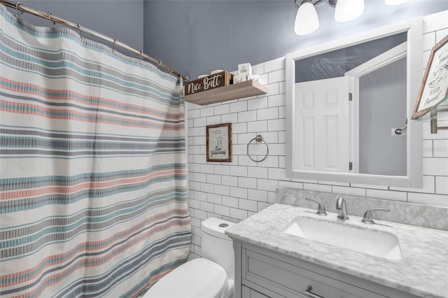 bathroom featuring a shower with shower curtain, vanity, toilet, and tile walls