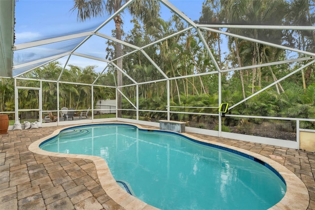 view of pool with a lanai and a patio