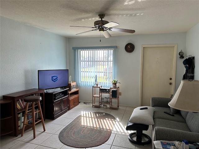 tiled living room with a textured ceiling and ceiling fan