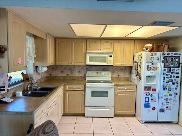 kitchen featuring light brown cabinets, white appliances, sink, and light tile patterned floors