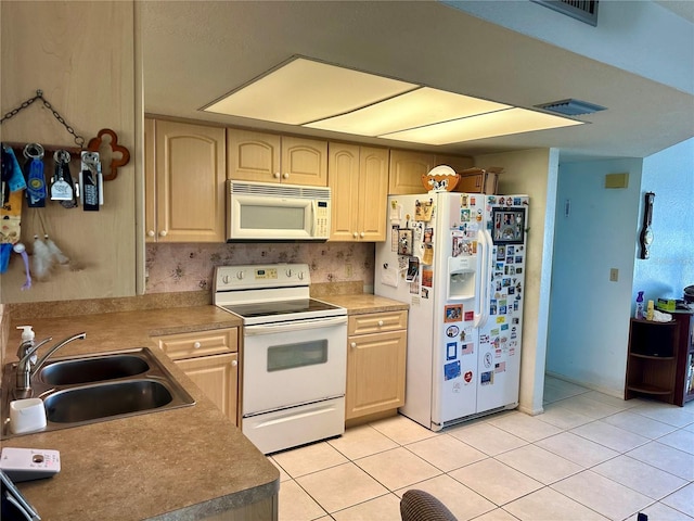 kitchen with light tile patterned floors, white appliances, light brown cabinetry, and sink