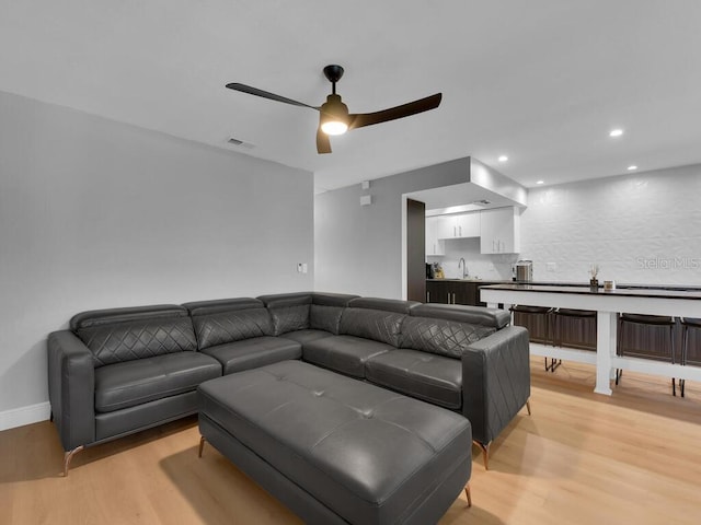 living room featuring recessed lighting, visible vents, light wood-type flooring, and ceiling fan