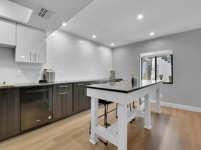 kitchen with dishwasher, light hardwood / wood-style floors, dark brown cabinetry, and white cabinetry