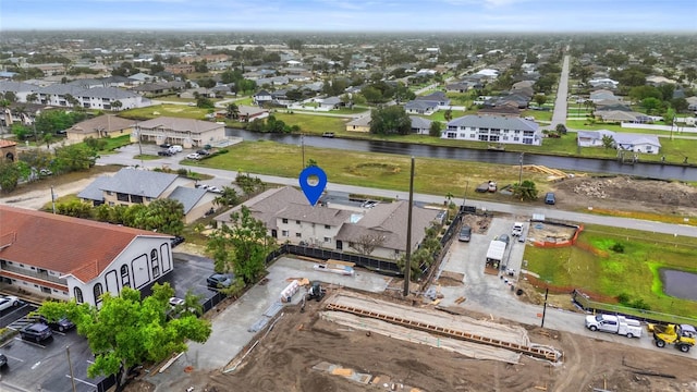 drone / aerial view featuring a residential view and a water view