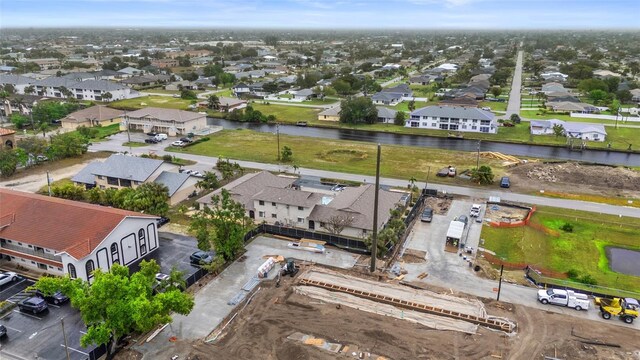 drone / aerial view with a residential view and a water view