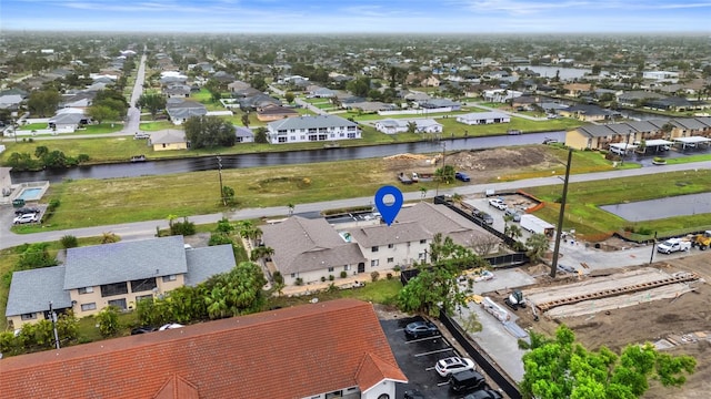 birds eye view of property with a residential view and a water view