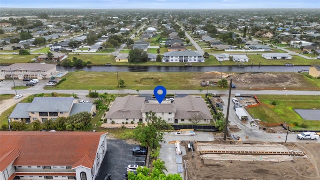 drone / aerial view featuring a residential view and a water view