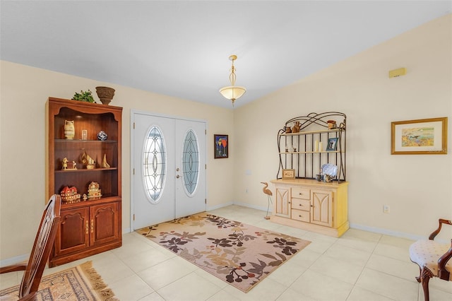 entryway with light tile patterned flooring and french doors