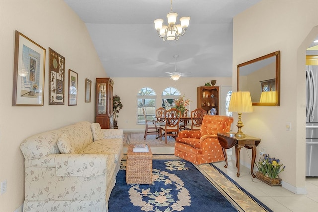 living room featuring ceiling fan with notable chandelier, lofted ceiling, and light tile patterned flooring