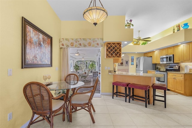 dining area featuring light tile patterned flooring