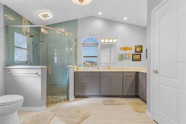 bathroom with vanity, lofted ceiling, tile patterned flooring, toilet, and a shower with shower door