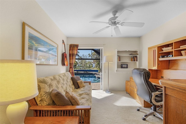 carpeted office featuring ceiling fan